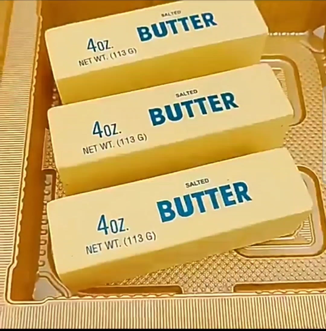 Three 4oz packages of salted butter squishy on a gold tray.